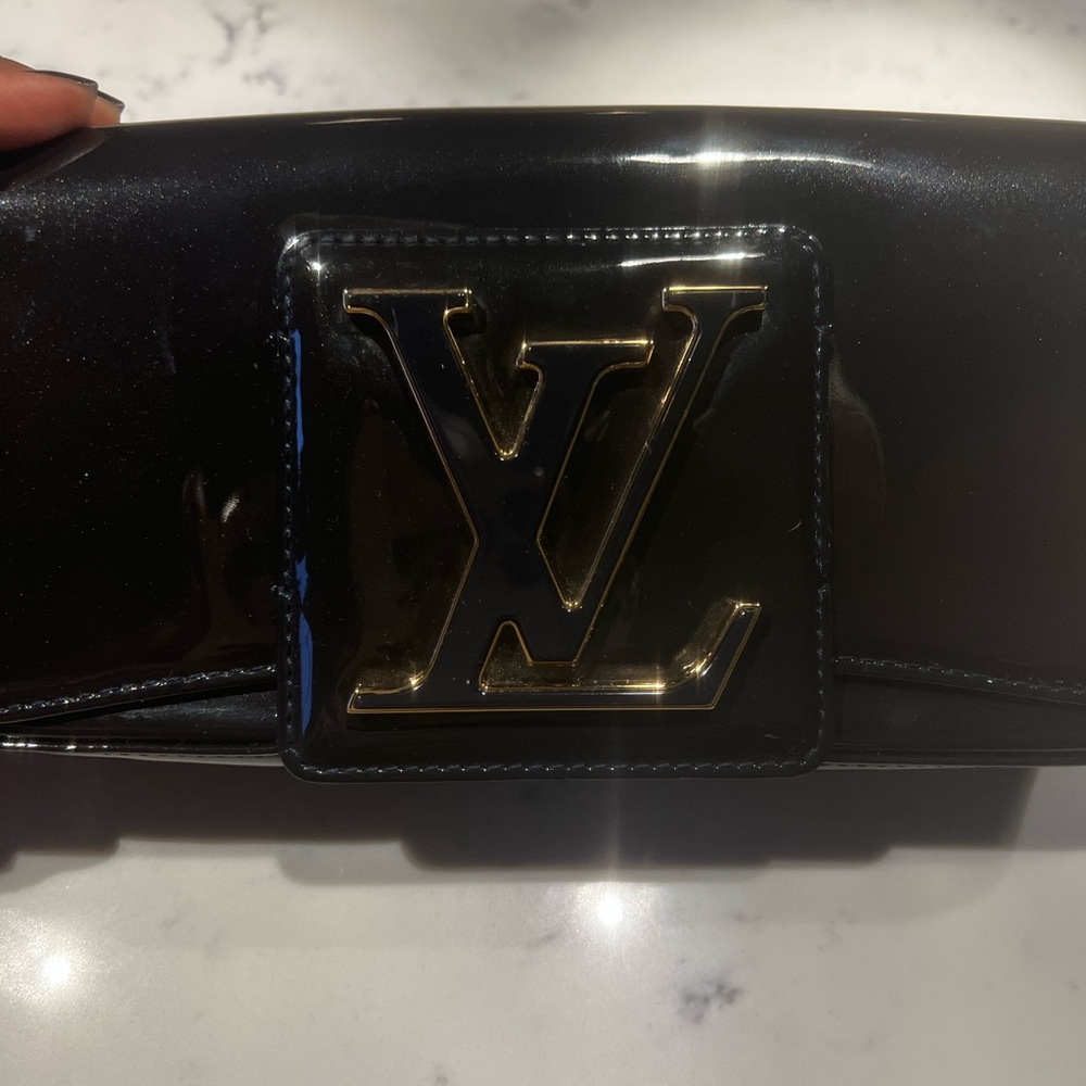 “ I’m just trying to make it “ Louis Vuitton clutch bag